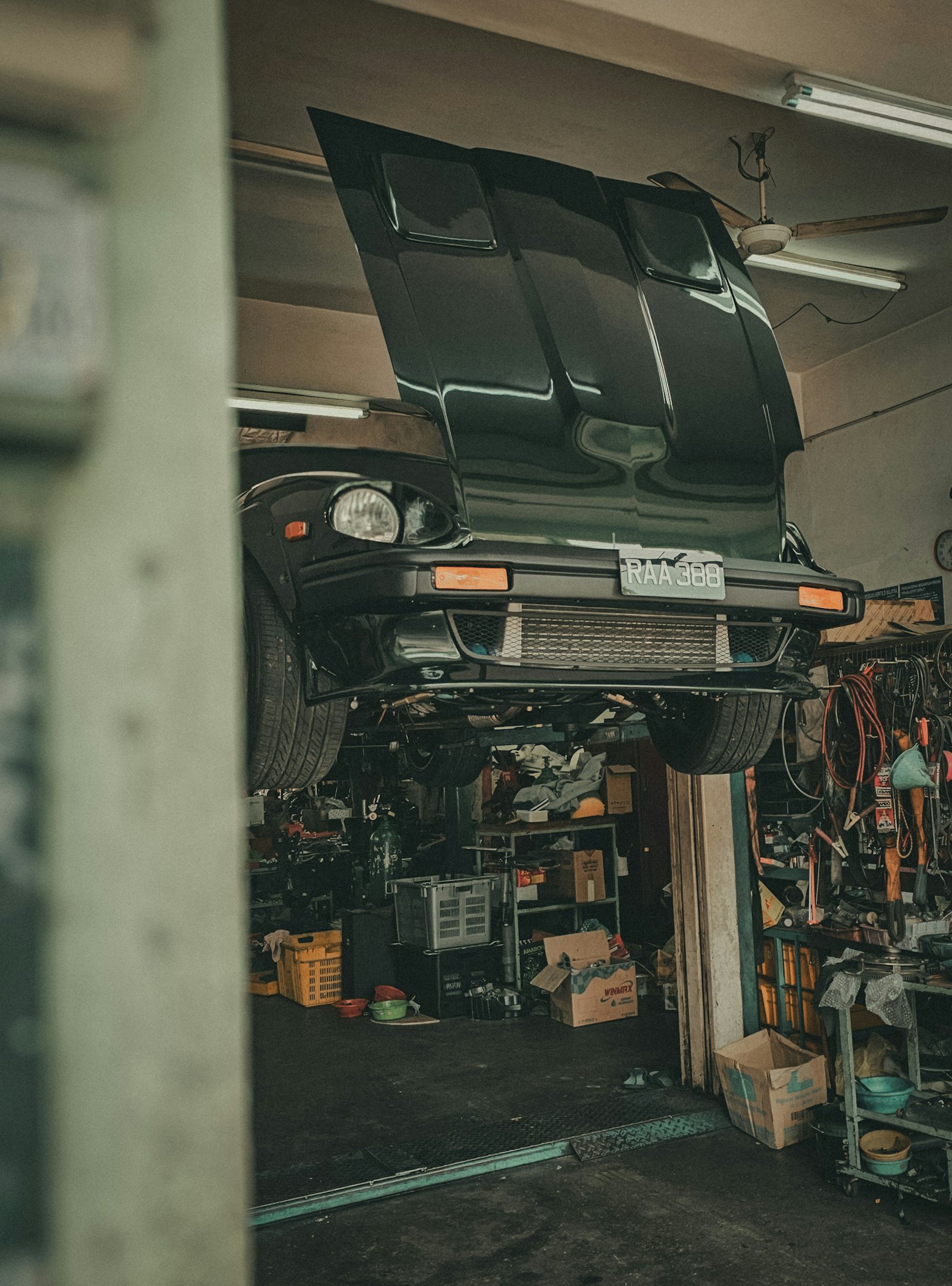 Car raised on a lift in a repair shop